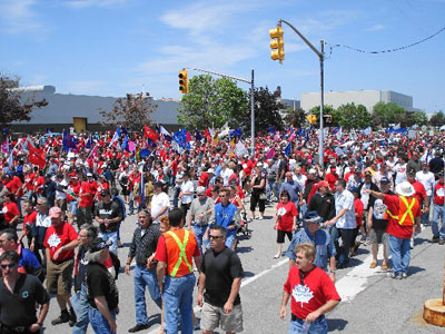 In June of 2008 General Motors announced the closure of their Oshawa truck plant. A militant demonstration of 5,000 workers marched around the plant with the main slogan “SAVE OUR JOBS!”